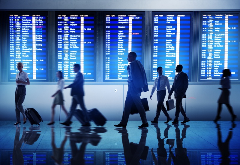 tlots of people walking near the departures board on a layover