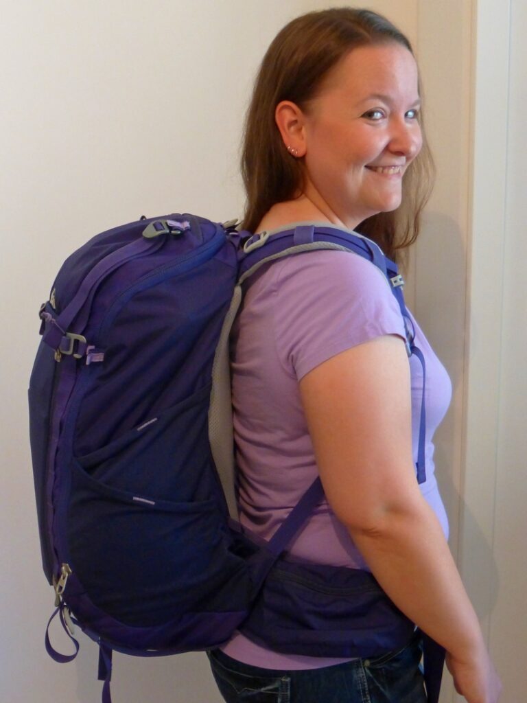 Ali wearing a purple REI backpack